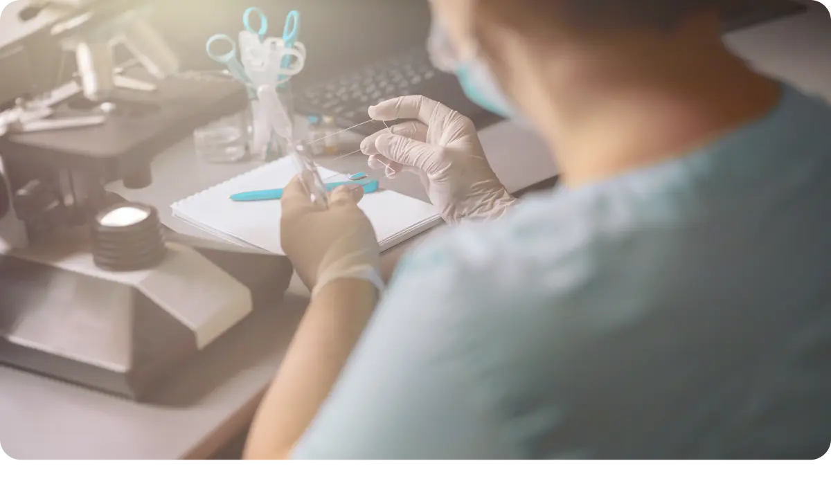 Woman covers transparent liquid drop with slide research table lab.